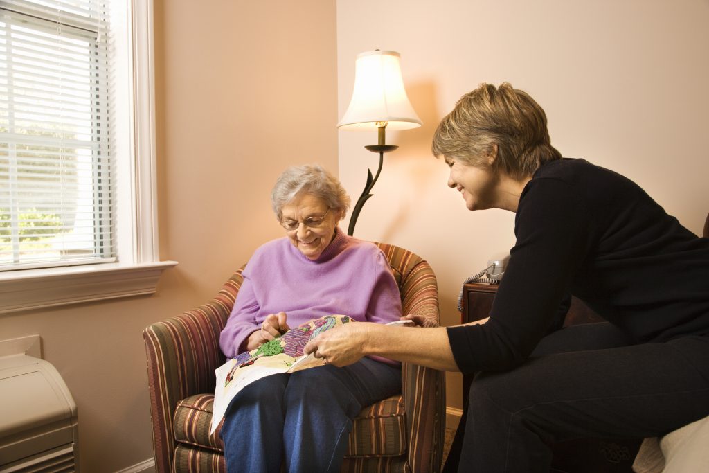 elderly woman doing crafts