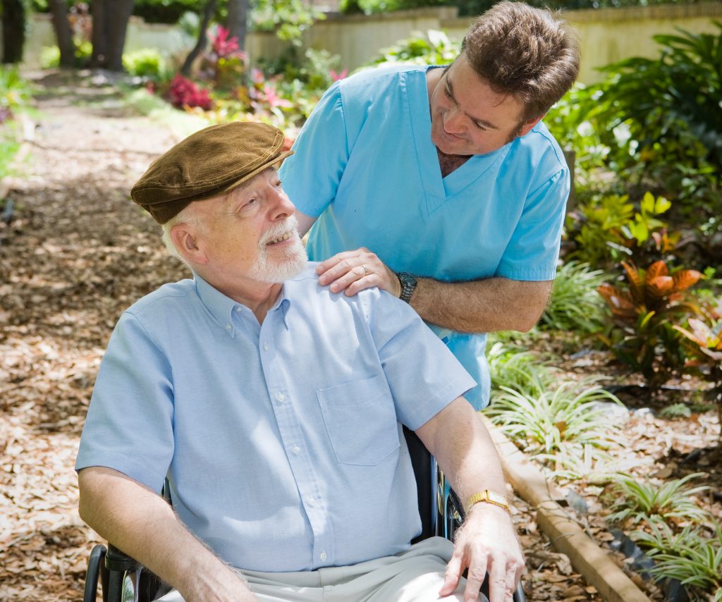 nurse assisting an elderly man
